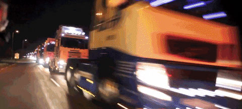 an animation showing semi trucks passing quickly on a highway, used as a metaphor to explain realtime analytics