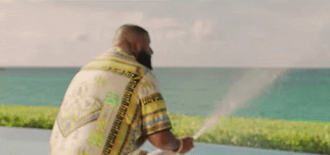 A gif showing a man celebrating by spraying champagne everywhere
